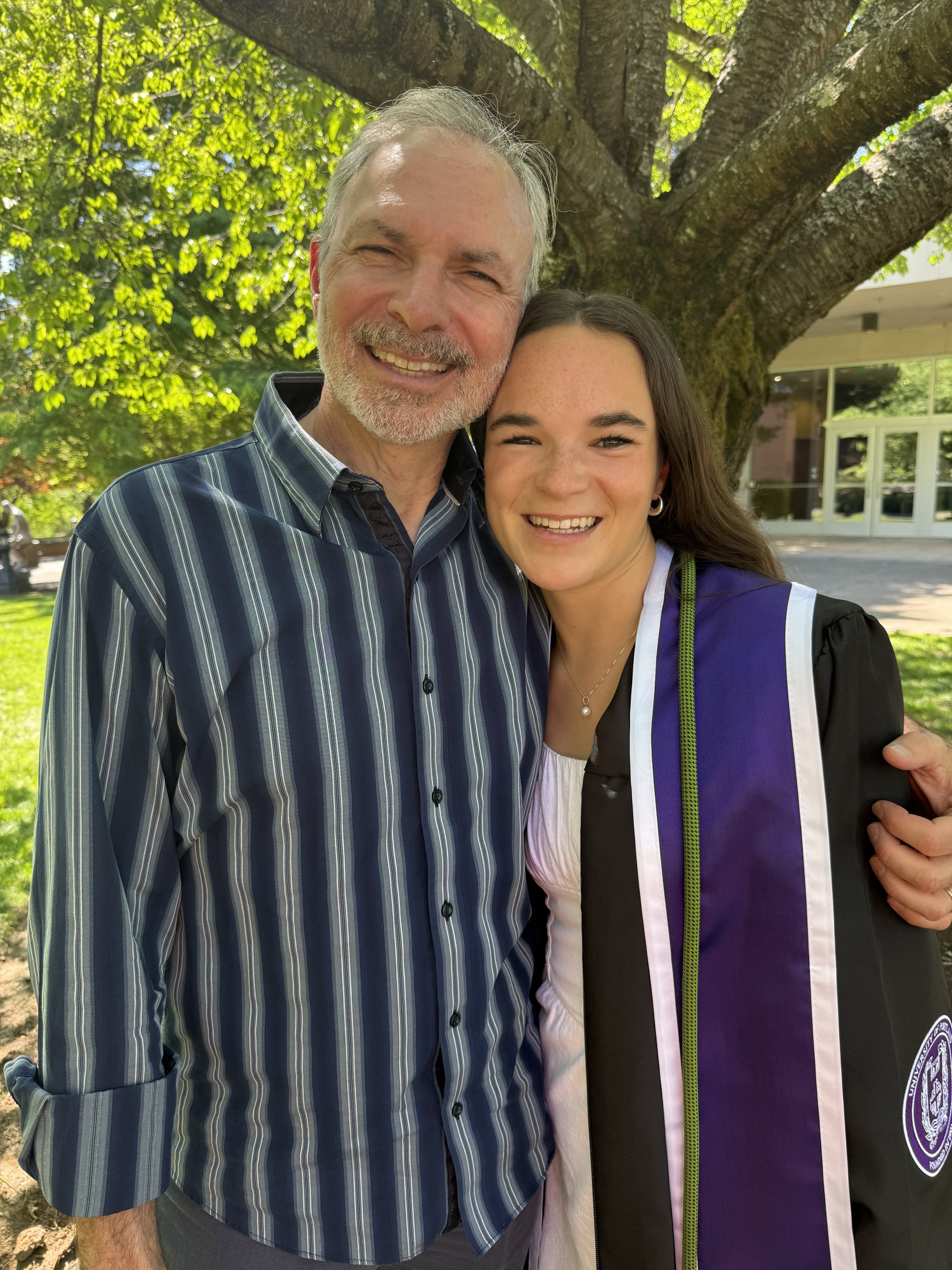 A parent and teen reviewing college costs together