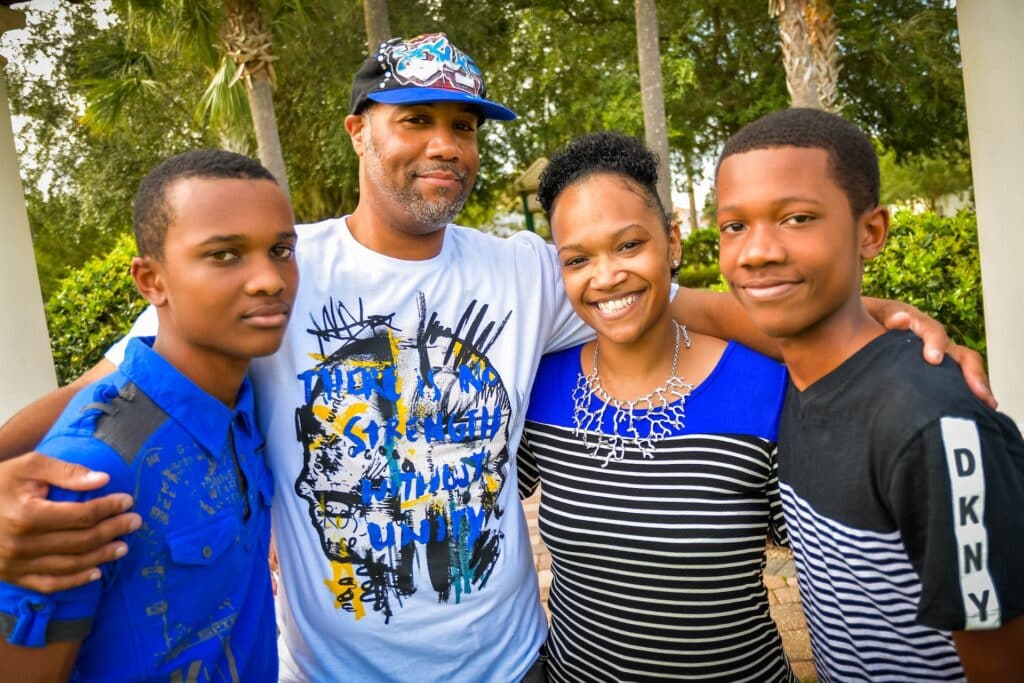 A happy family photo consisting of a mother, father, and two sons.